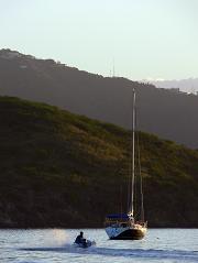 A yacht on a lake, with a
dinghy going to meet it