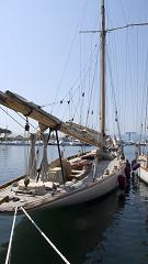 A yacht tied up on a sunny day in harbour,
perhaps ready to depart on a long voyage.